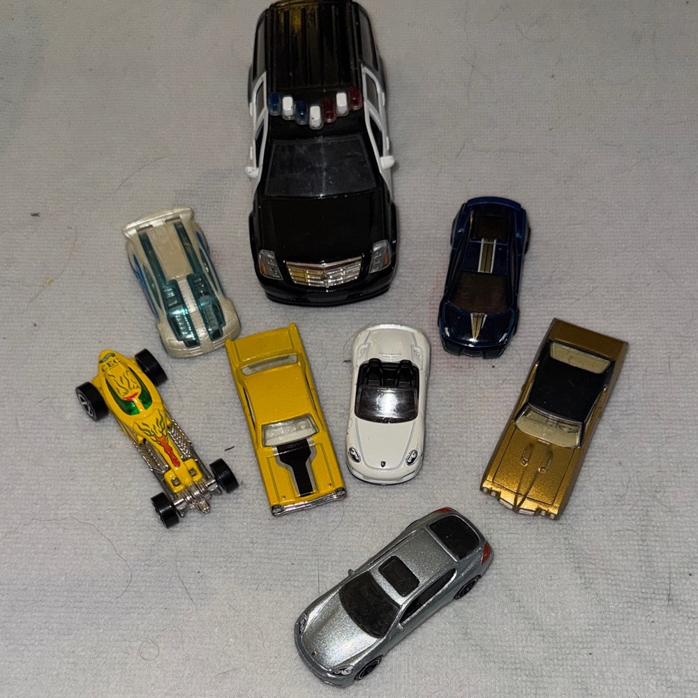 Die-Cast Toy Car Collection with Black, White, and Gold Vehicles
